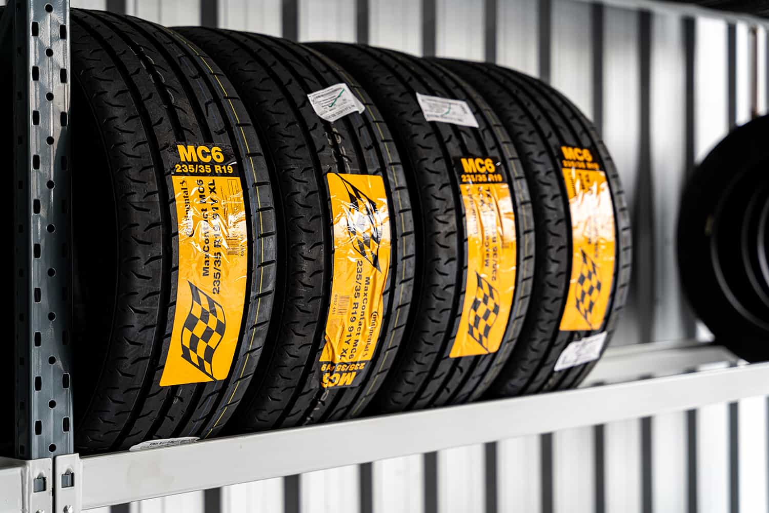 new car tyres on rack shelving ready for Tyre Replacement & Fitting in Brisbane