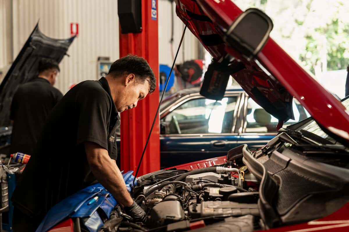 Brisbane Euro Service professional auto mechanic working on car engine.